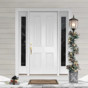 Elegant white front door with glass panels, adorned with festive greenery, lantern, and a welcome mat, creating a warm holiday entrance.
