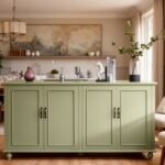 Stylish green kitchen island with decorative items, surrounded by a modern dining area featuring elegant furniture and natural light. Perfect for home decor inspiration.