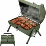 Portable green grill with smoked meats, including steaks and sausages, showcasing an outdoor cooking experience perfect for barbecues and gatherings.