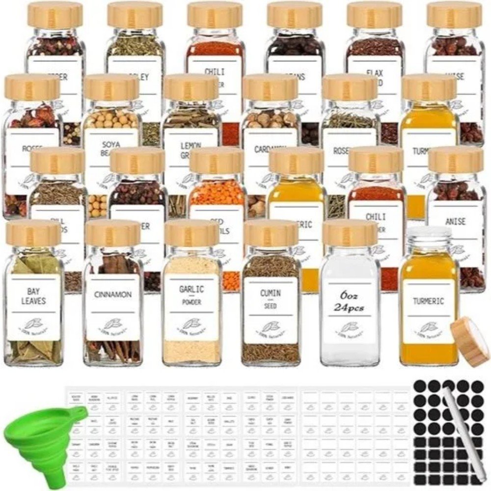 A collection of 24 spice jars with labeled contents, including turmeric, cumin, and chili powder, alongside a green funnel and labeling stickers.