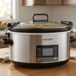 Crockpot slow cooker on a wooden kitchen countertop, featuring a digital display and glass lid, ideal for easy meal preparation and cooking.
