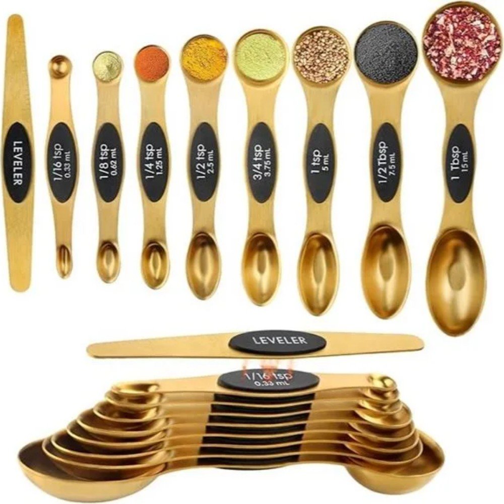 Set of gold measuring spoons with various sizes, including a leveller tool, ideal for precise cooking and baking measurements in the kitchen.