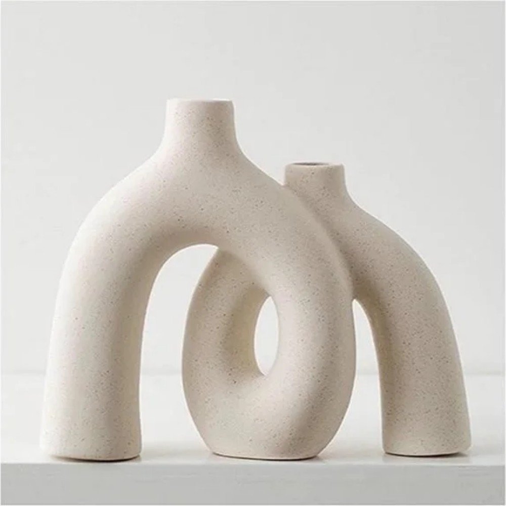 Elegant ceramic vases with unique shapes, perfect for modern home decor, featuring a minimalist design in a soft neutral color.