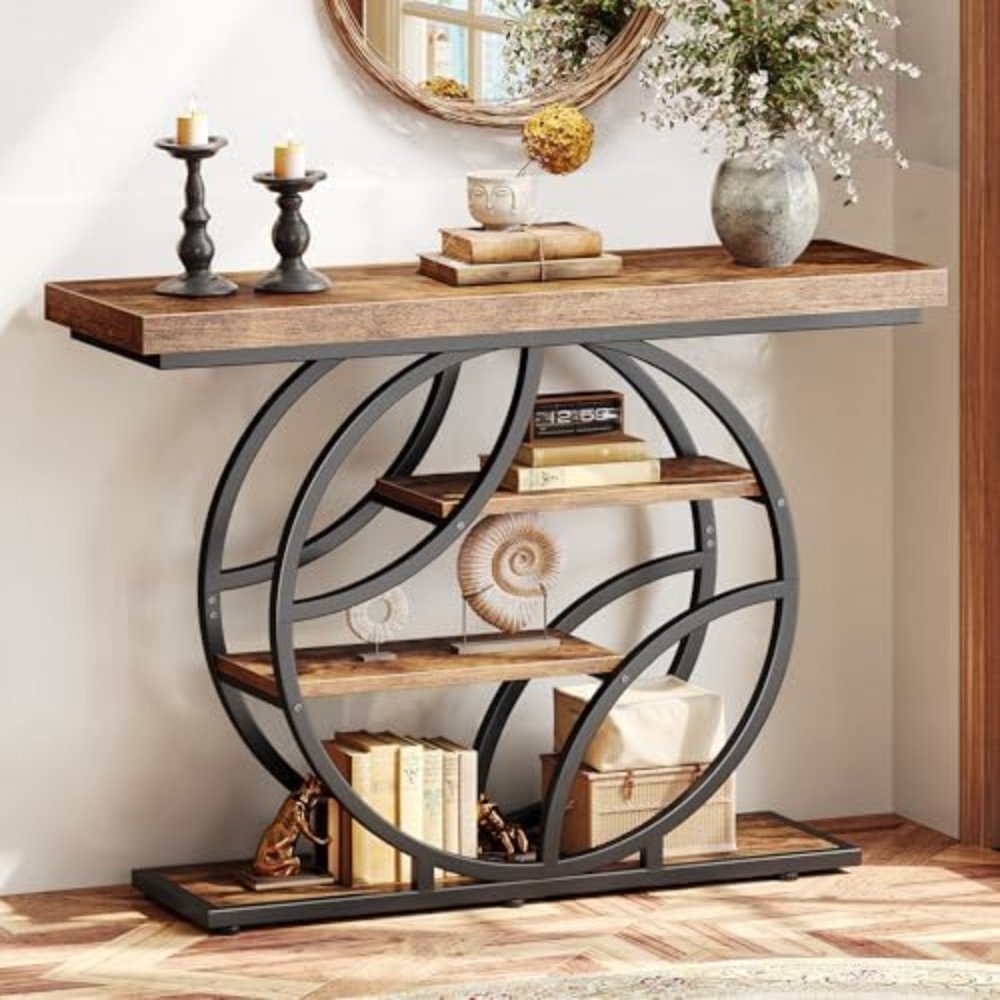Stylish wooden console table with circular metal frame, decorative candles, books, and unique decor items, enhancing modern home interior design.