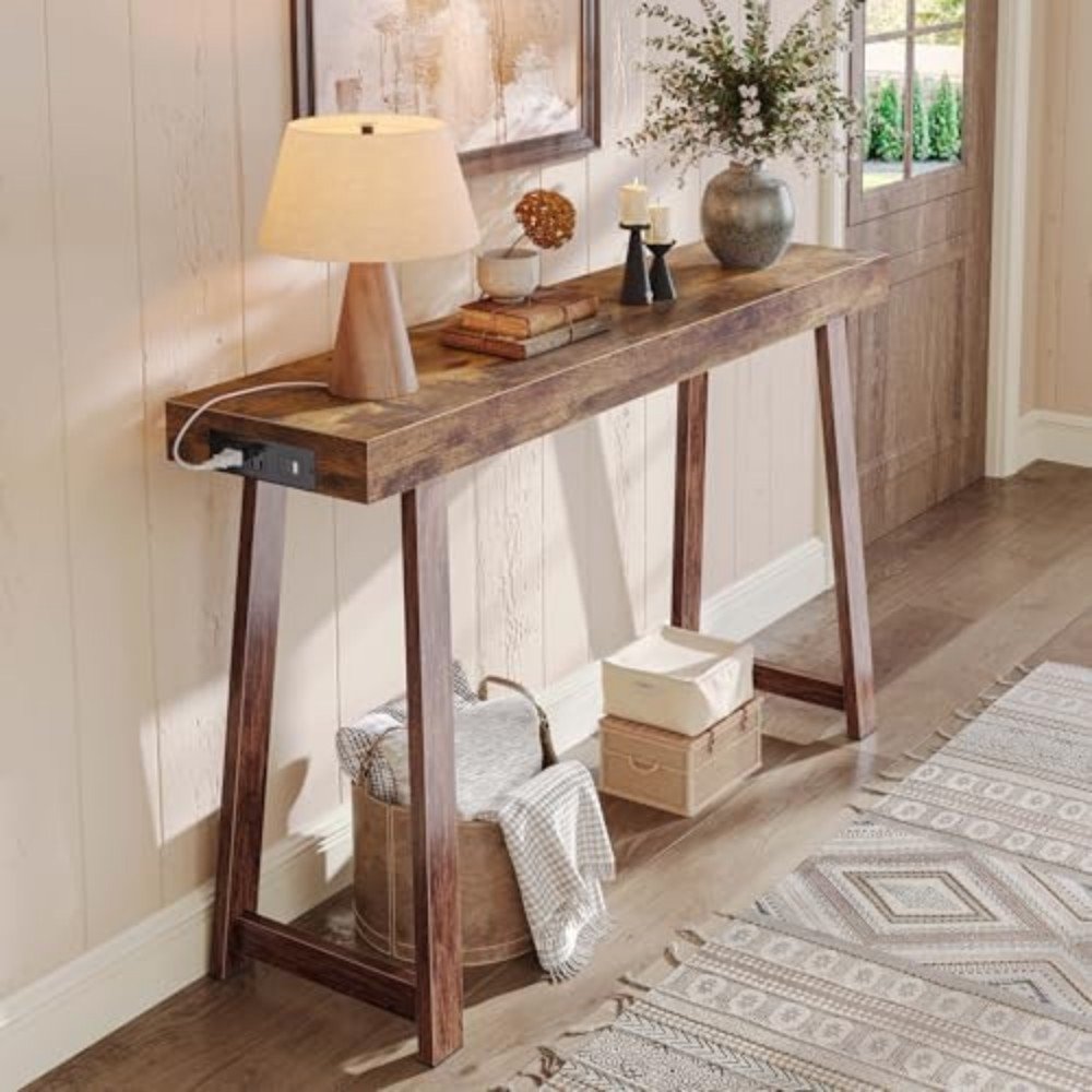 Rustic console table with lamp, decorative items, and storage baskets in a stylish entryway, enhancing home decor and functionality.