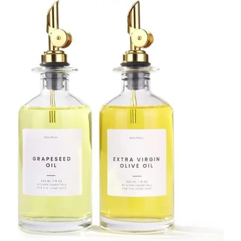 Grapeseed oil and extra virgin olive oil in elegant glass bottles, perfect for culinary use and enhancing flavors in home cooking.