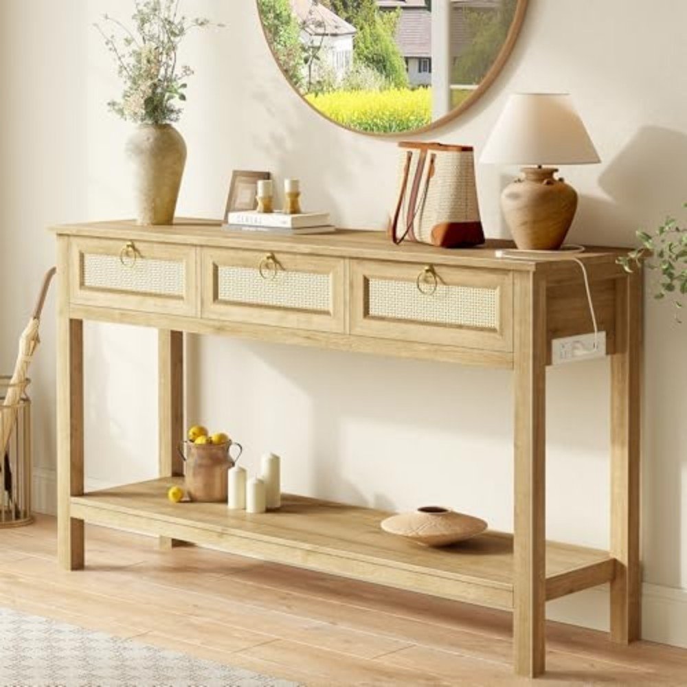 Stylish wooden console table with three drawers, decorative items, and a round mirror, enhancing a modern living space's aesthetic appeal.