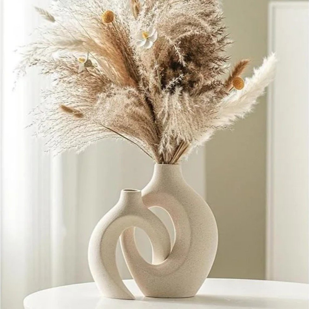 Elegant beige vases with pampas grass and floral accents, perfect for home decor, enhancing modern and minimalist interior designs.