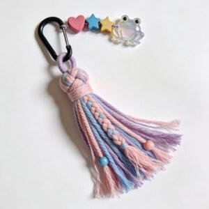 Colorful handmade tassel keychain featuring braided yarn, beads, and a frog charm, perfect for adding a whimsical touch to bags or keys.