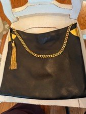 black leather Gucci 1970 handbag features a gold-toned chain strap and a matchin