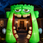 Bright green Frankenstein inflatable archway, surrounded by glowing jack-o'-lanterns, exemplifying the best Halloween inflatable arches for festive outdoor decorations.