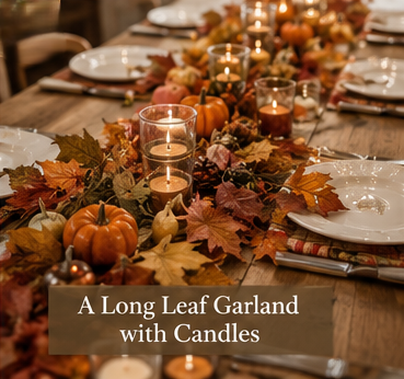 Long leaf garland centerpiece with candles and pumpkins, perfect for autumn dining table decor in fall gatherings and celebrations.