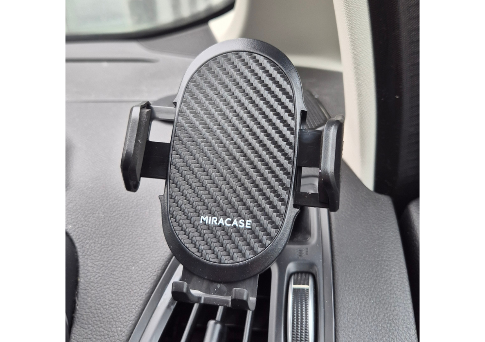 Car air vent mobile phone holder providing hands-free convenience, featuring a sleek carbon fiber design for secure and stylish in-car use.