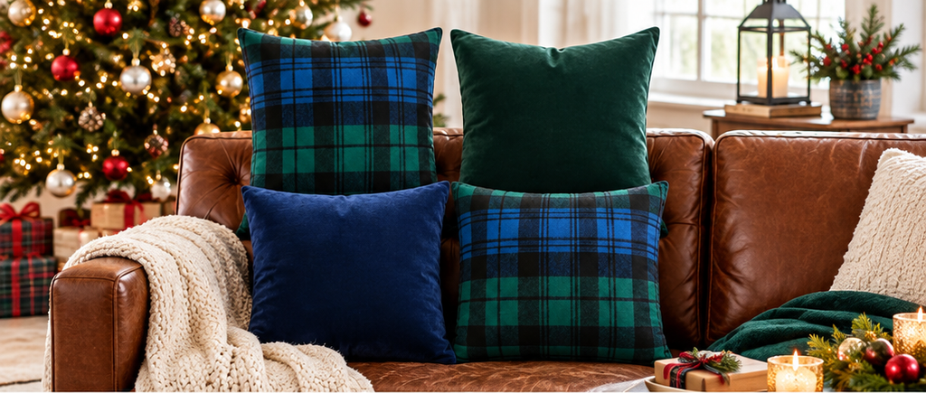 Navy and tartan pillows on a cozy leather sofa with Christmas tree and festive decor, enhancing holiday style with elegance and warmth.