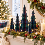 Navy and tartan Christmas decor on mantel with candles, greenery, and festive lights, enhancing holiday ambiance.