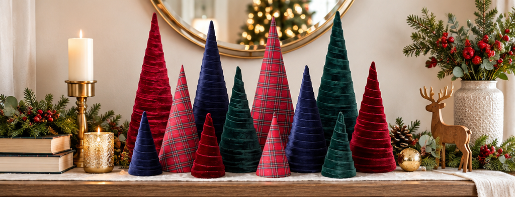 Festive display of navy and tartan cone trees with candles and greenery, perfect for elegant Christmas decor.